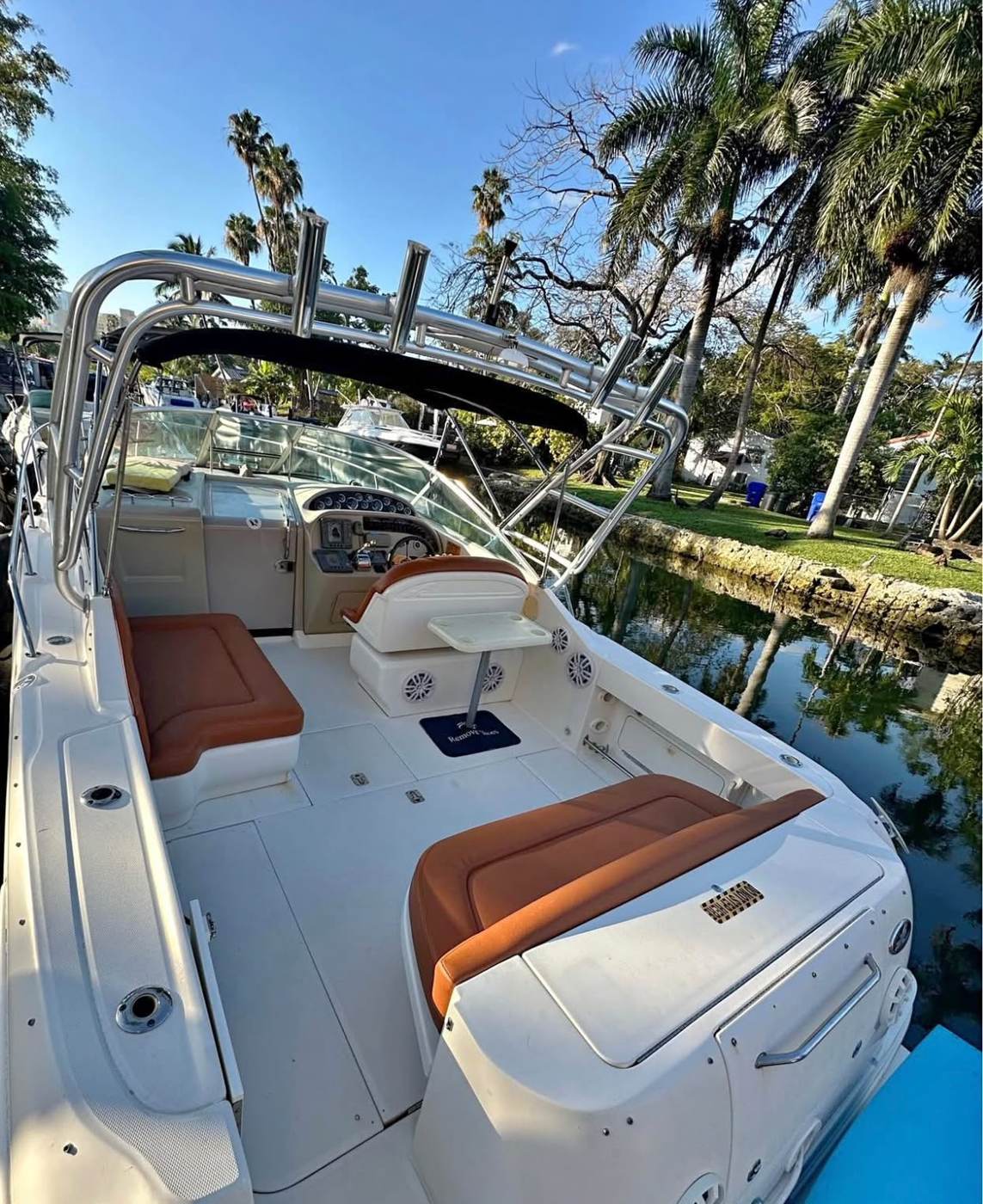 The cockpit alongside the dock, coral upholstery and the arch above