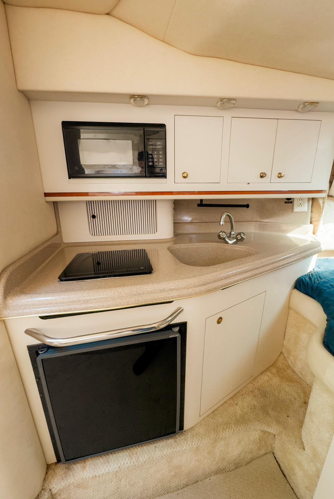 The galley, with sink, cooktop, microwave and fridge