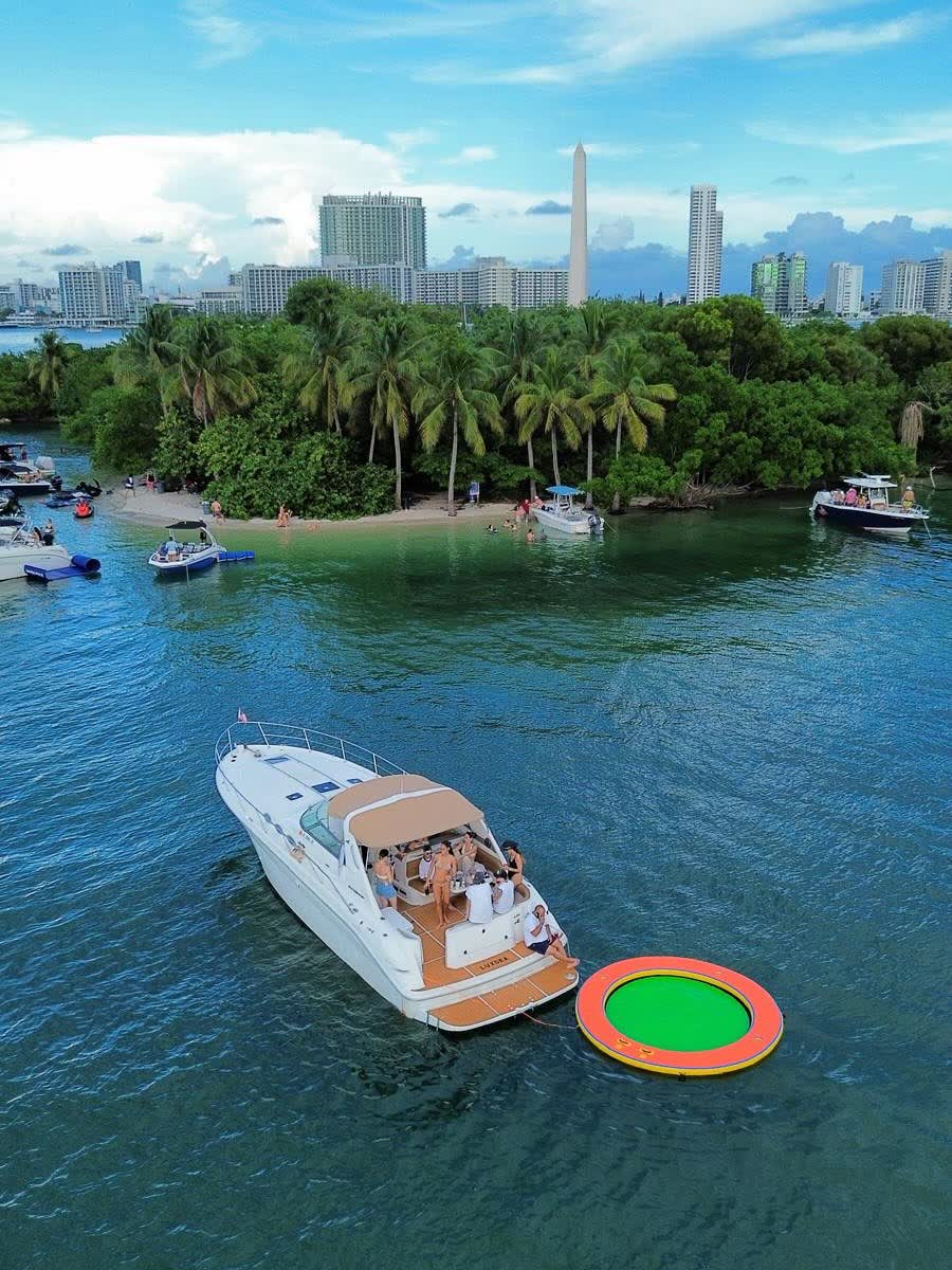 Anchored close to a mangrove island in flat green water, the float streamed astern