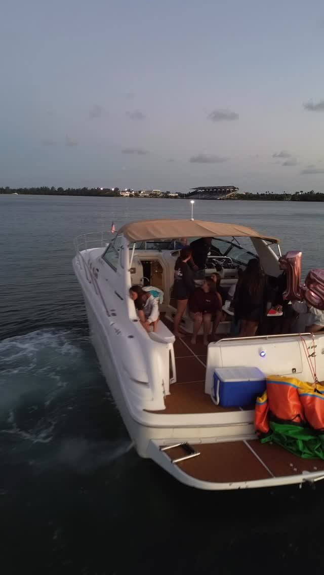 A LuxSea boat running back across the bay in low golden light with the skyline behind