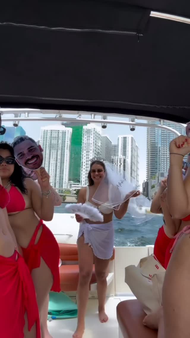 Guests on the covered deck with the downtown towers across the water